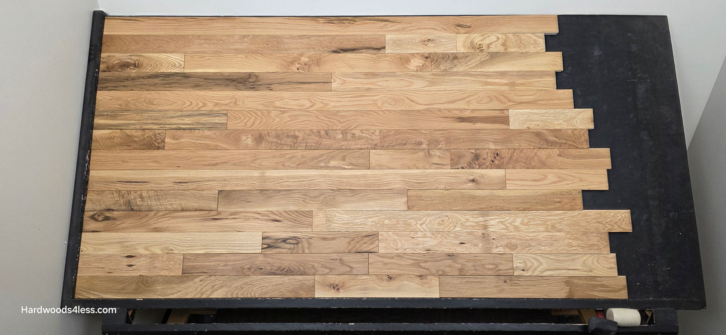 3 1/4" x 3/4" Solid White Oak Natural Character Grade Hardwood Flooring. Shown on a black shooting table. Shot from center. 