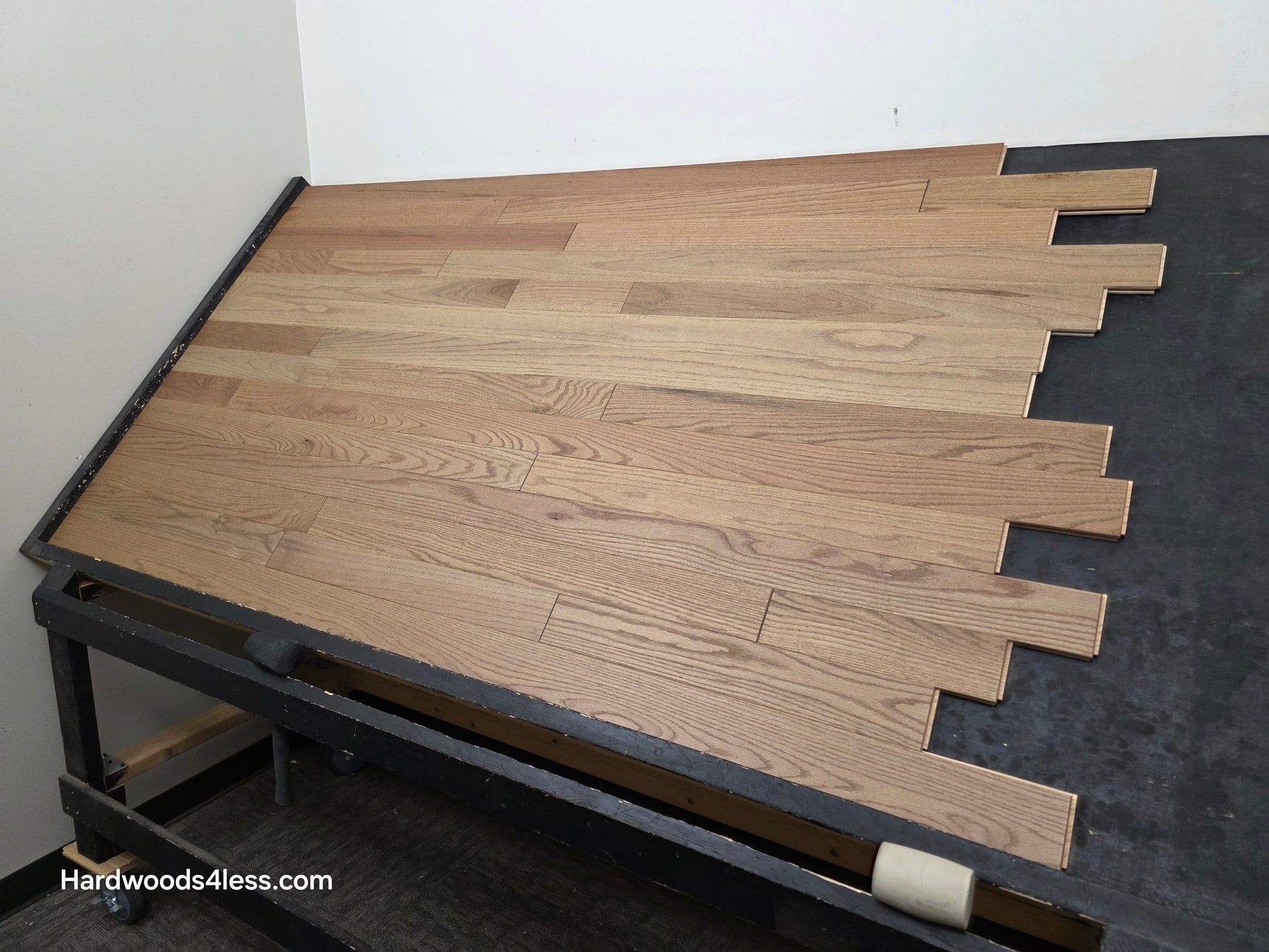 3 1/4" x 3/4" Solid White Oak Rye Hardwood Flooring. Shown on a black shooting table. Shot from wide right. 