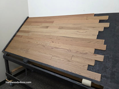 3 1/4" x 3/4" Solid White Oak Rye Hardwood Flooring. Shown on a black shooting table. Shot from wide right. 