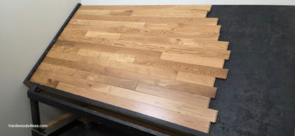 3 1/4" x 3/4" White Oak Natural Hardwood Flooring. Shown on a black shooting table. Right hand shot.