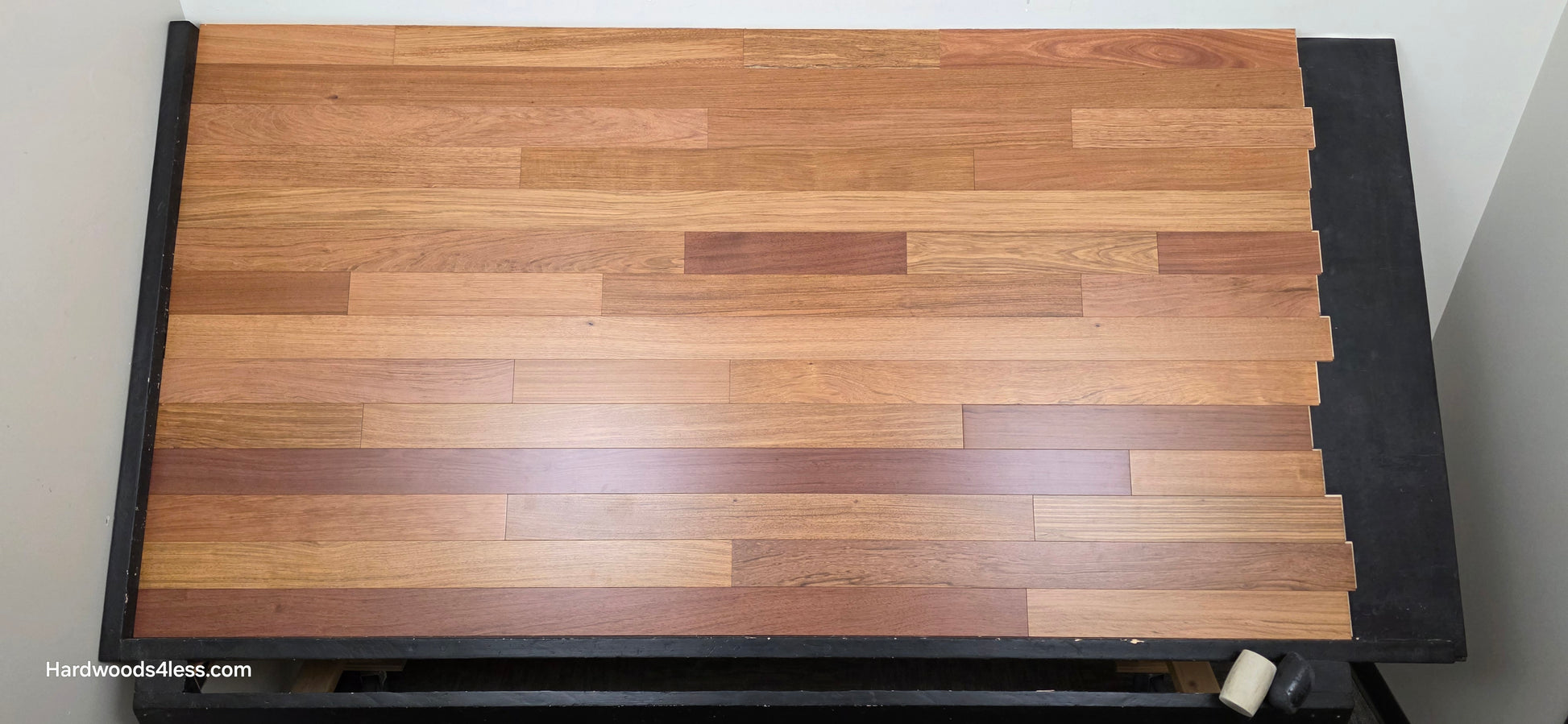 3 1/4" x 3/8" Engineered Brazilian Cherry Hardwood Flooring. Shown on a black shooting table. Shot from center.