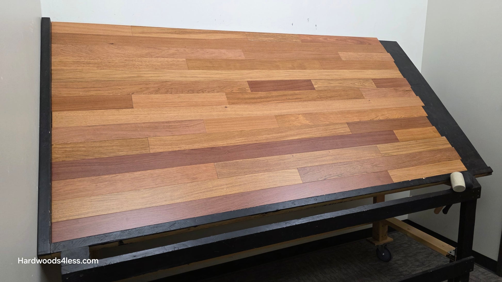 3 1/4" x 3/8" Engineered Brazilian Cherry Hardwood Flooring. Shown on a black shooting table. Shot from wide left 