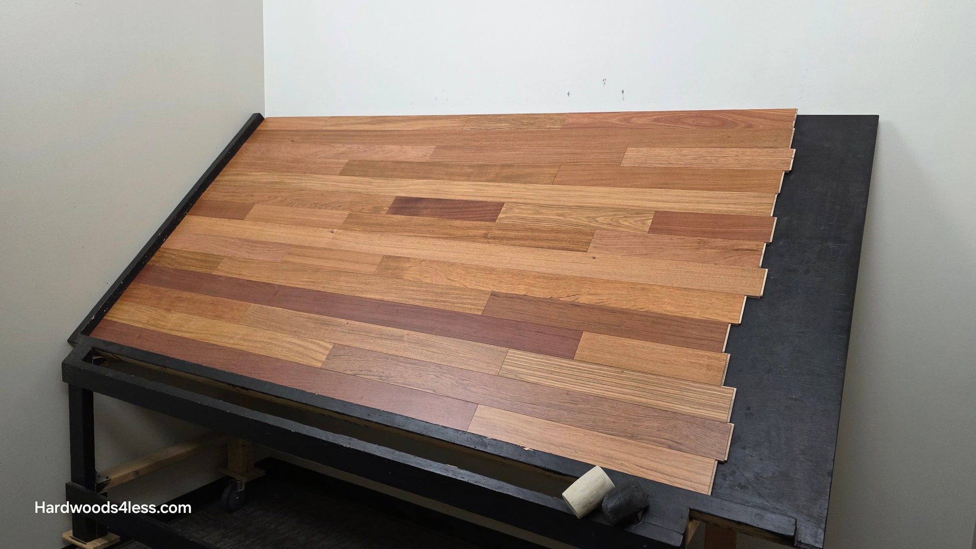 3 1/4" x 3/8" Engineered Brazilian Cherry Hardwood Flooring. Shown on a black shooting table. Shot from wide right.