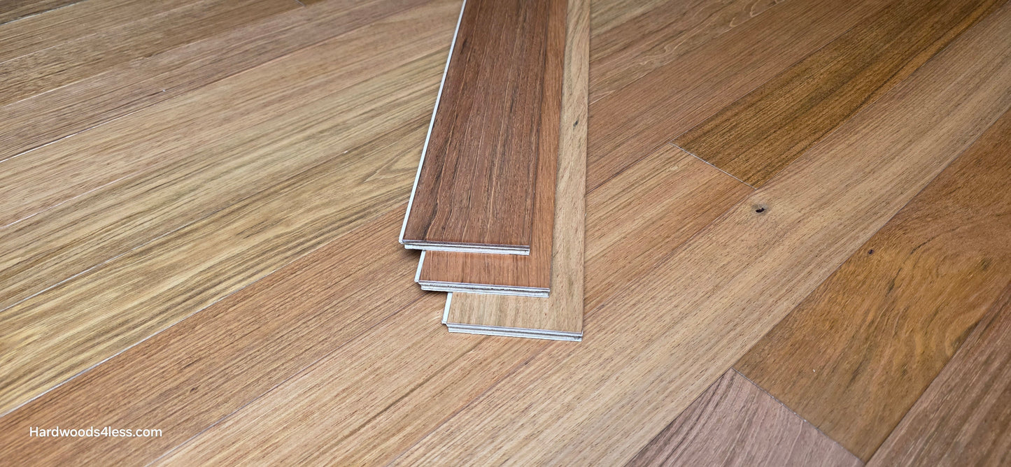 3 1/4" x 3/8" Engineered Brazilian Cherry Hardwood Flooring. Shown as three boards stacked on top of the flooring.