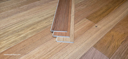 3 1/4" x 3/8" Engineered Brazilian Cherry Hardwood Flooring. Shown as three boards stacked on top of the flooring.