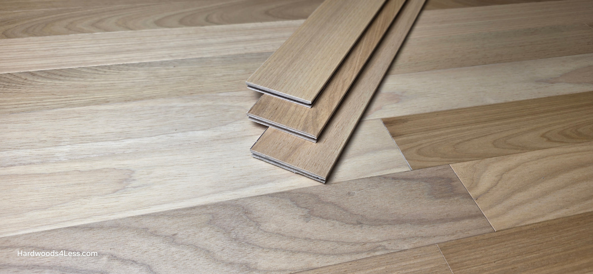 3 1/4" x 3/8" Engineered Brazilian Oak Natural Hardwood Flooring. Shown at center is a stack of three Brazilian oak boards. Stacked on top of the flooring. 