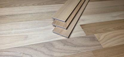 3 1/4" x 3/8" Engineered Brazilian Oak Natural Hardwood Flooring. Shown at center is a stack of three Brazilian oak boards. Stacked on top of the flooring. 