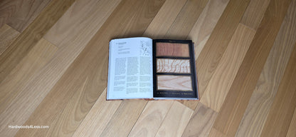3 1/4" x 3/8" Engineered Brazilian Oak Natural Hardwood Flooring. Shown at center is a Hardwood book opened to a random Oak page. Under the book is the Brazilian Oak Flooring.