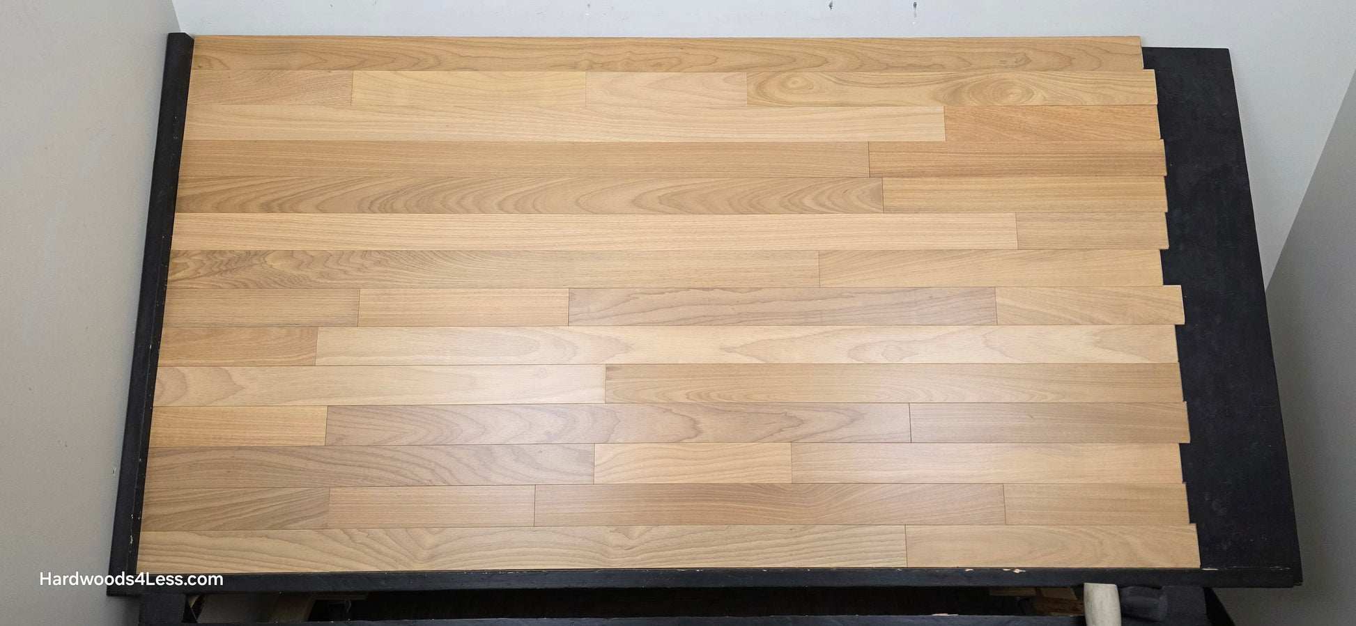 3 1/4" x 3/8" Engineered Brazilian Oak Natural Hardwood Flooring. Shown on a a black shooting table. Shot from center.