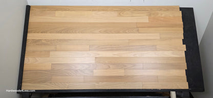 3 1/4" x 3/8" Engineered Brazilian Oak Natural Hardwood Flooring. Shown on a a black shooting table. Shot from center.