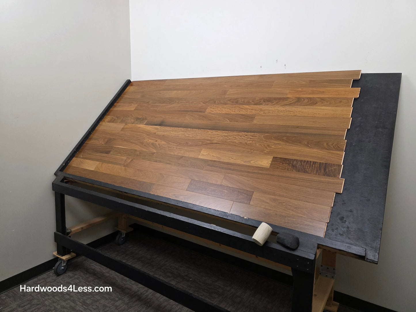 3 1/4" x 3/8" Engineered Brazilian Walnut (IPE) Natural Hardwood Flooring. Shown on a black shooting table. Shot from wide right.