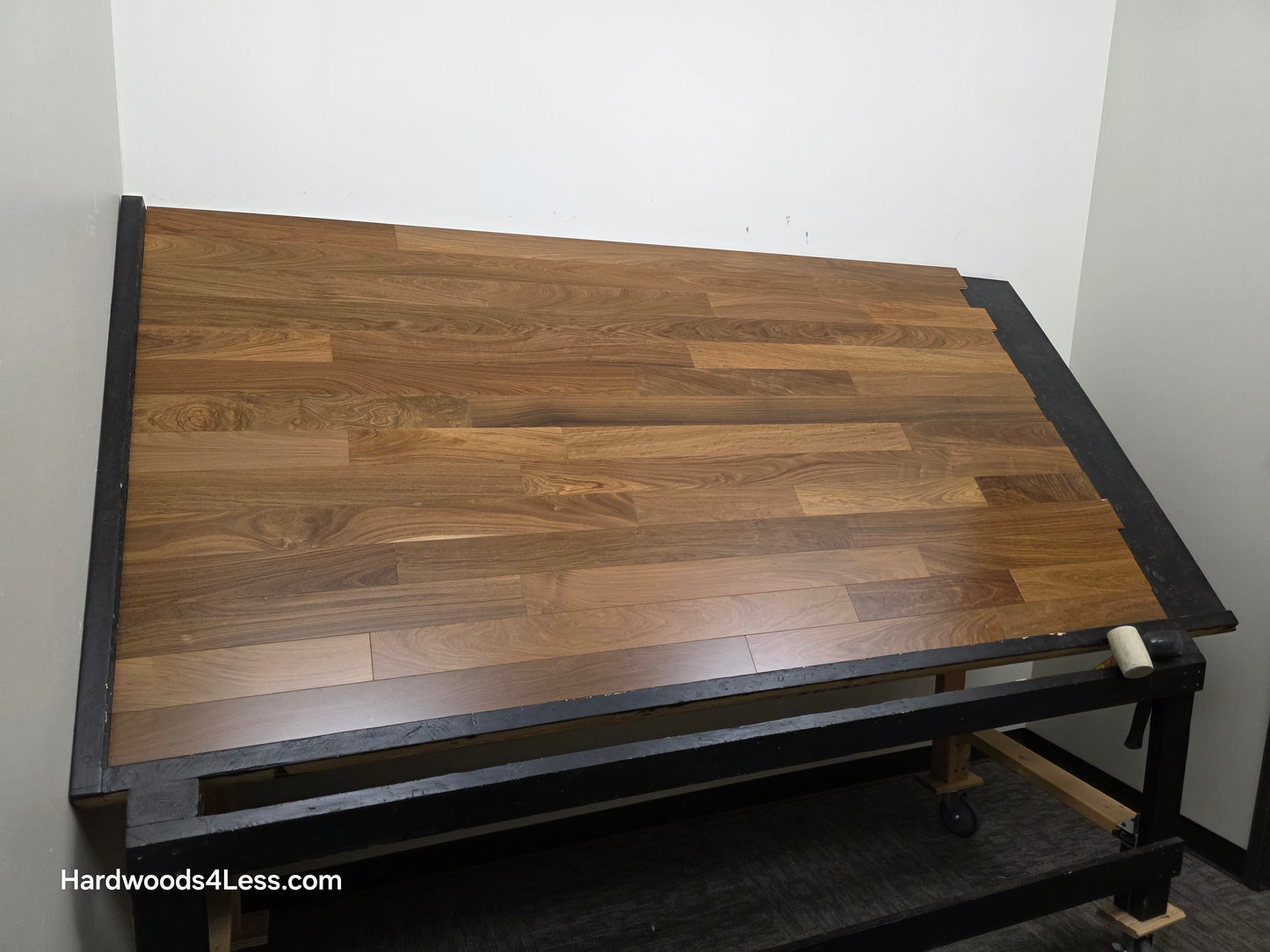 3 1/4" x 3/8" Engineered Brazilian Walnut (IPE) Natural Hardwood Flooring. Shown on a black shooting table. Shot from wide left. 