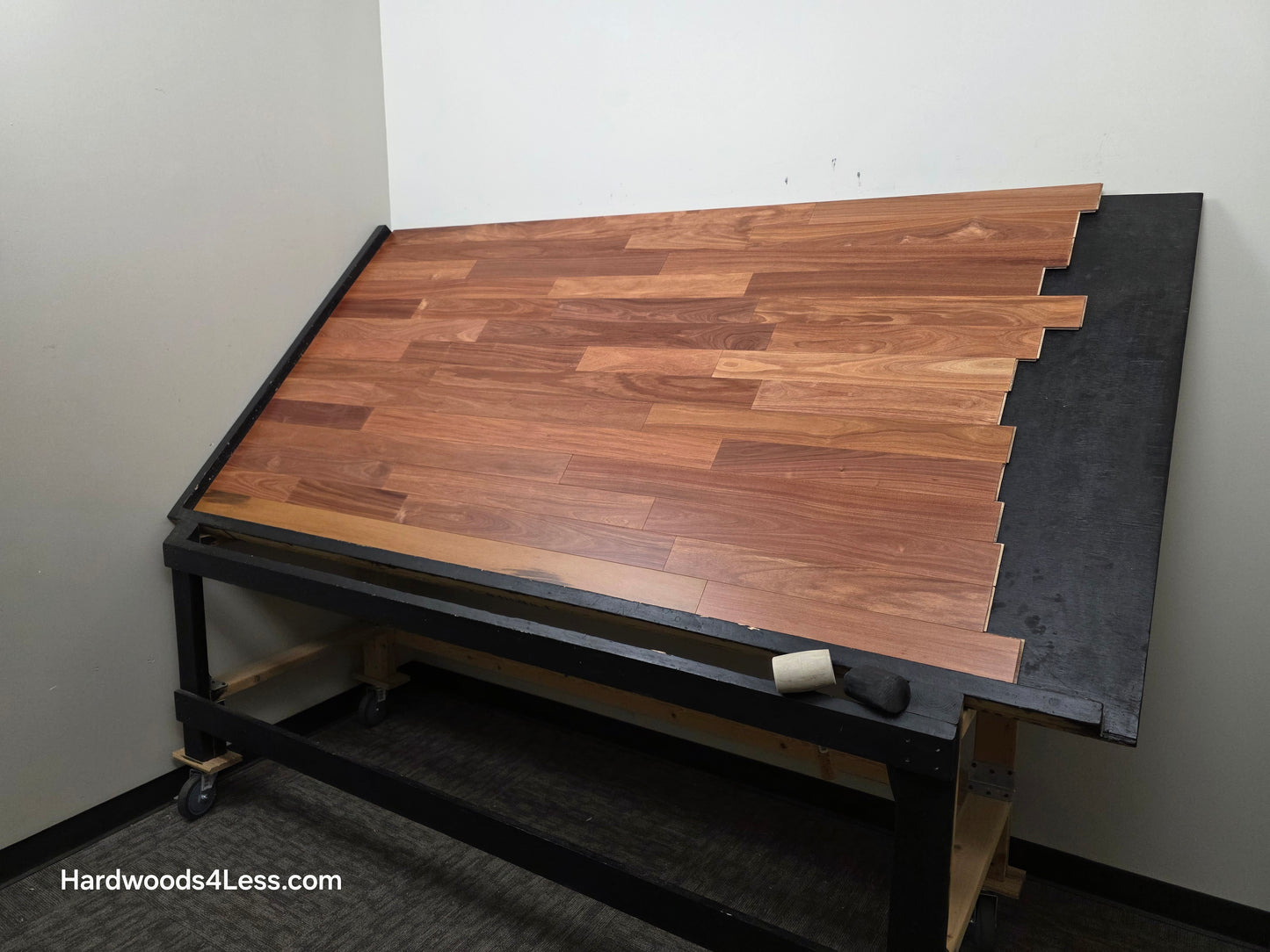 3 1/4" x 3/8" Engineered Santos Mahogany Hardwood Flooring. Shown on a black shooting table. Shot from wide right.