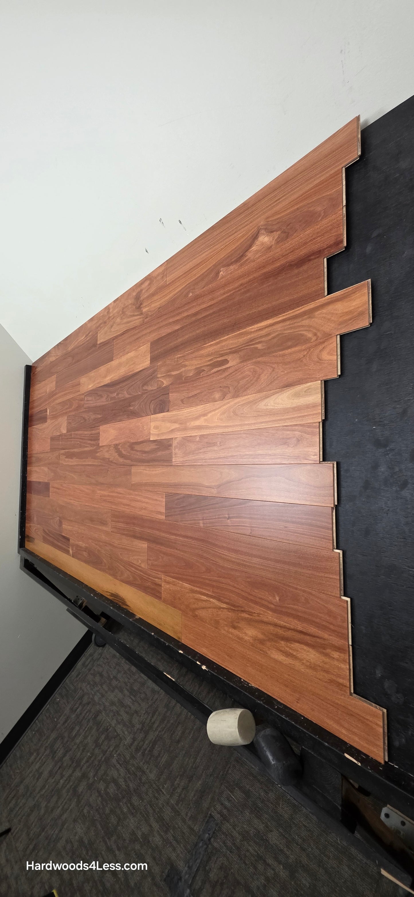 3 1/4" x 3/8" Engineered Santos Mahogany Hardwood Flooring. Shown on a black shooting table. Shot from steep right.