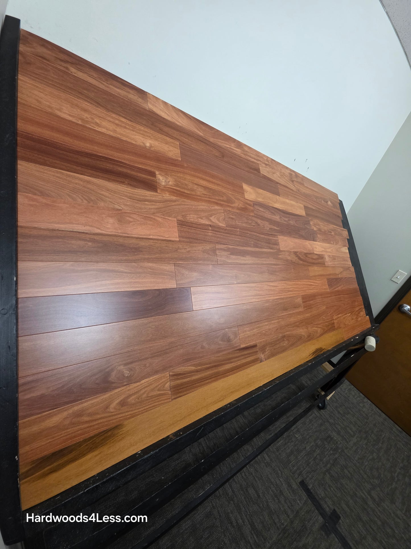 3 1/4" x 3/8" Engineered Santos Mahogany Hardwood Flooring. Shown on a black shooting table. Shot from steep left.