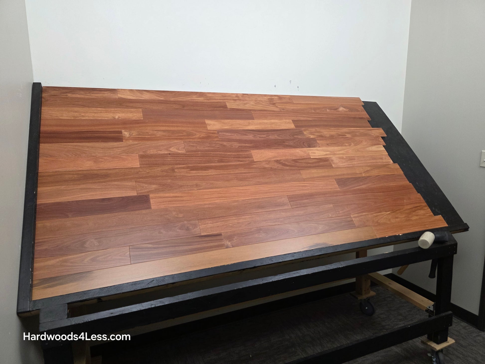 3 1/4" x 3/8" Engineered Santos Mahogany Hardwood Flooring. Shown on a black shooting table. Shot from wide left.