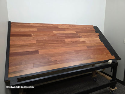 3 1/4" x 3/8" Engineered Santos Mahogany Hardwood Flooring. Shown on a black shooting table. Shot from wide left.