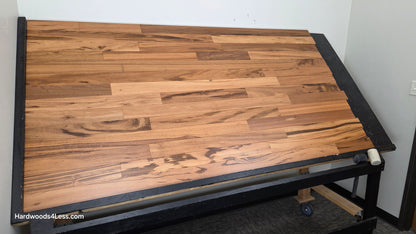 3 1/4" x 3/8" Engineered Tigerwood Hardwood Flooring. Shown on a black shooting table. Shot from wide left.