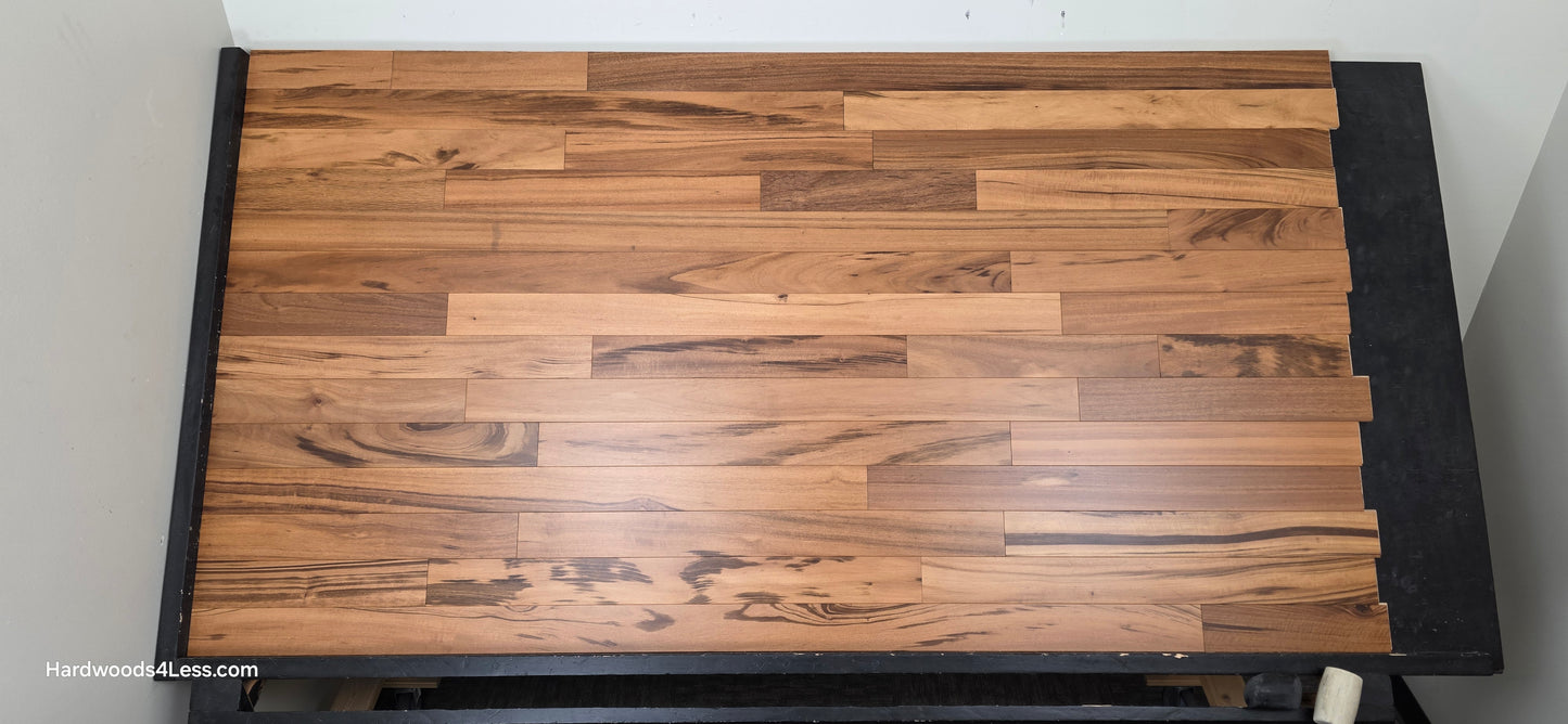 3 1/4" x 3/8" Engineered Tigerwood Hardwood Flooring. Shown on a black shooting table. Shot from center.