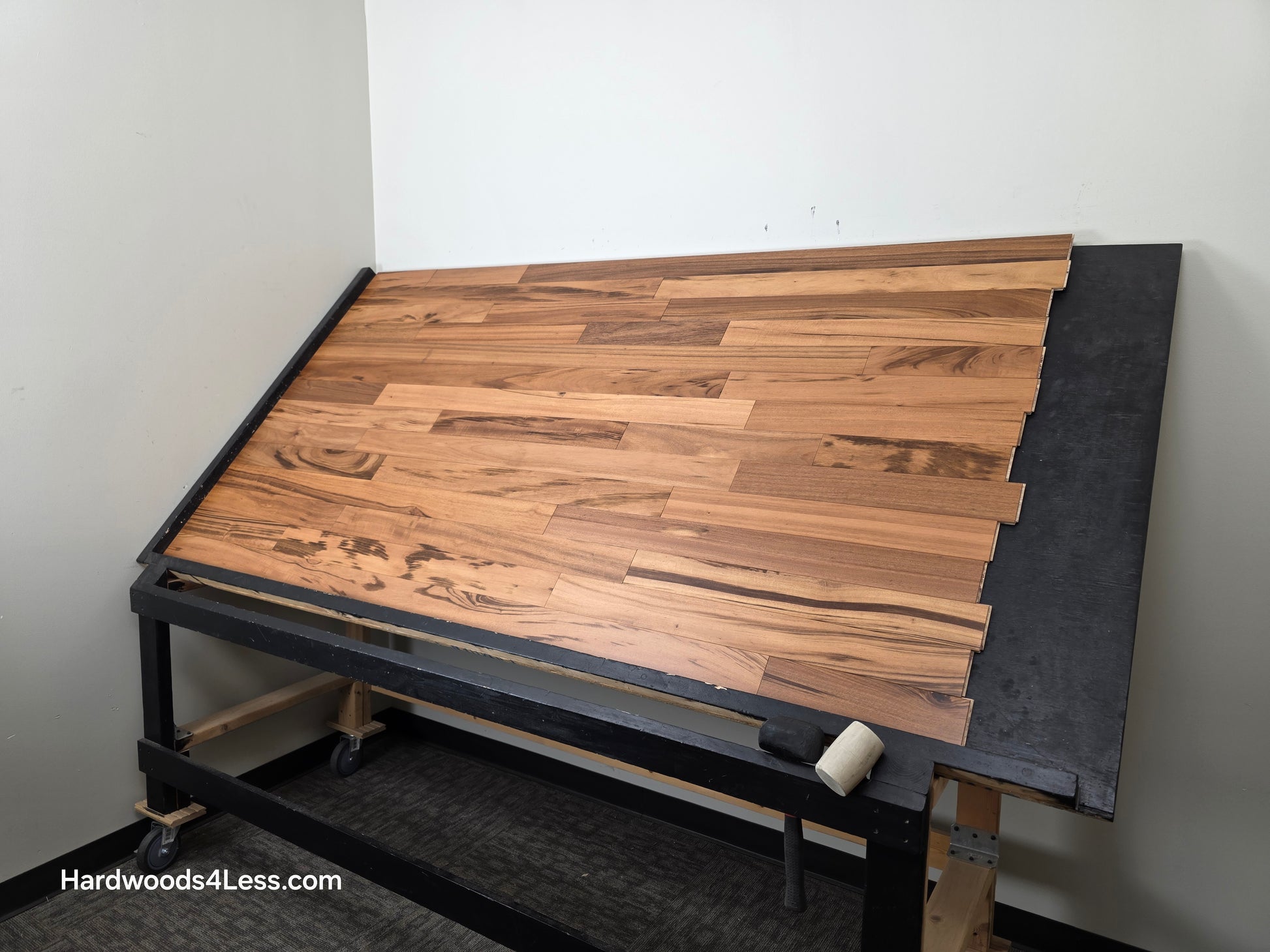 3 1/4" x 3/8" Engineered Tigerwood Hardwood Flooring. Shown on a black shooting table. Shot from wide right.