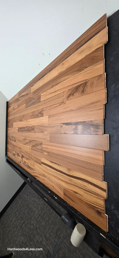 3 1/4" x 3/8" Engineered Tigerwood Hardwood Flooring. Shown on a black shooting table. Shot from steep right.