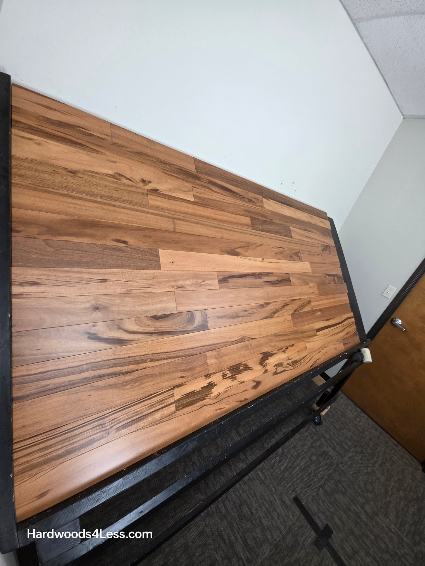 3 1/4" x 3/8" Engineered Tigerwood Hardwood Flooring. Shown on a black shooting table. Shot from steep left. 