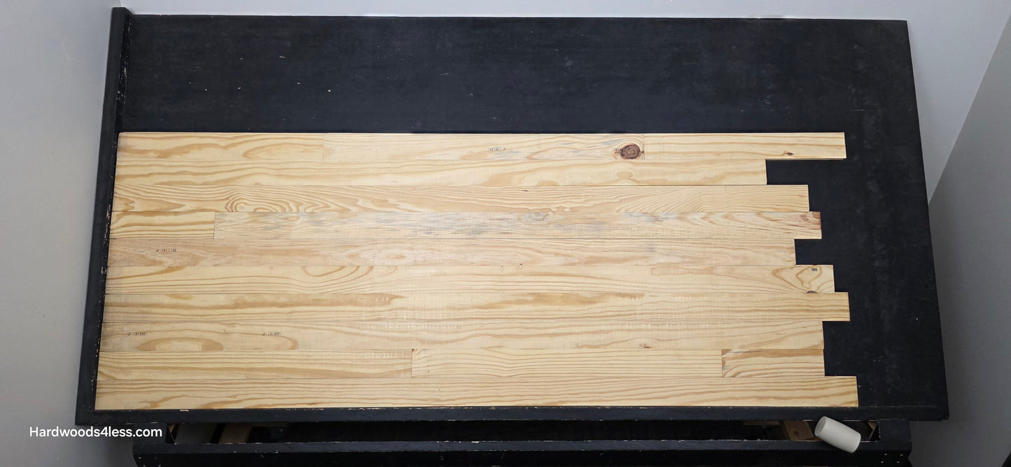 3 1/8" x 3/4" Unfinished Southern Yellow Pine Solid Hardwood Flooring. Shown on a black shooting table. Center shot.