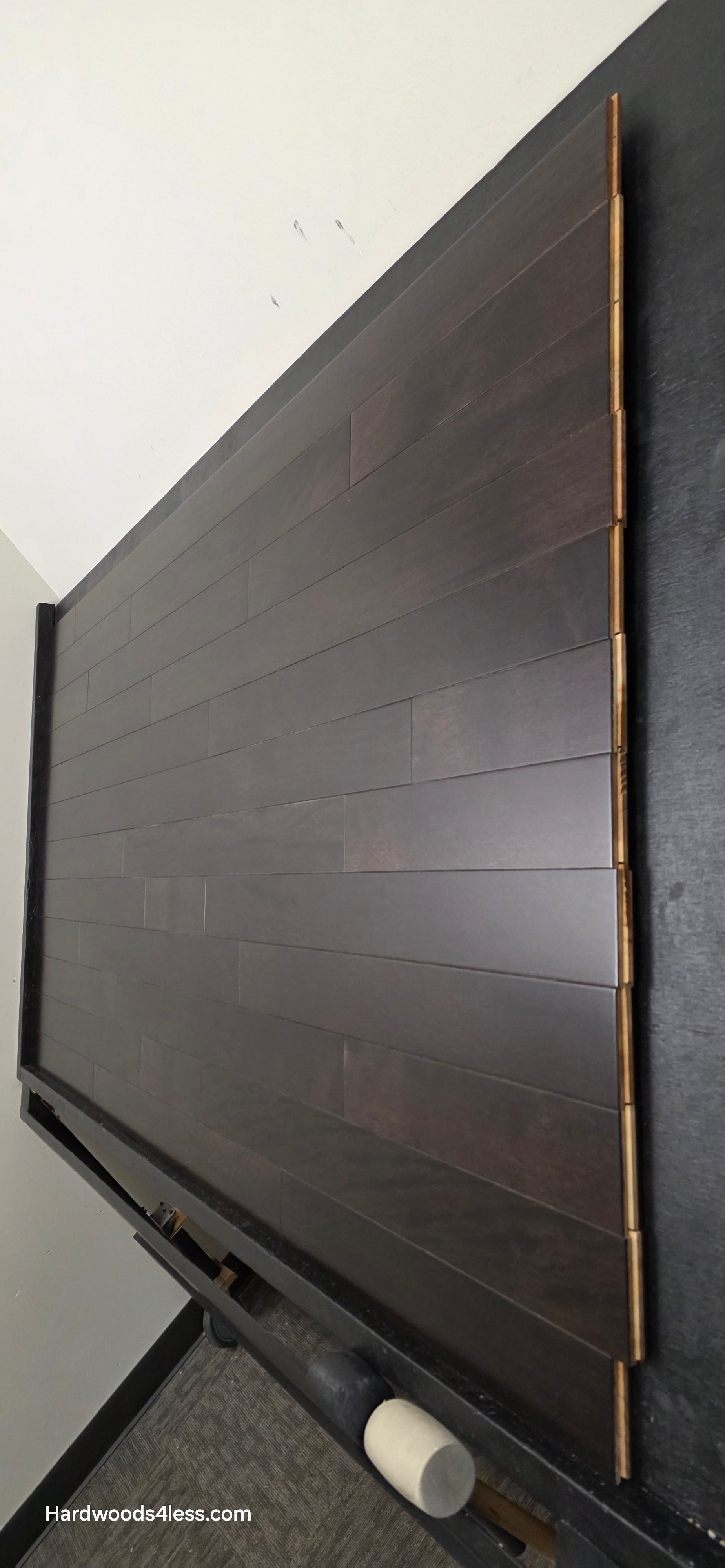 3 5/8" x 3/4" Solid Brazilian Oak Burnt Umber Hardwood Flooring. Shown on a black shooting table. Shot from wide steep right.