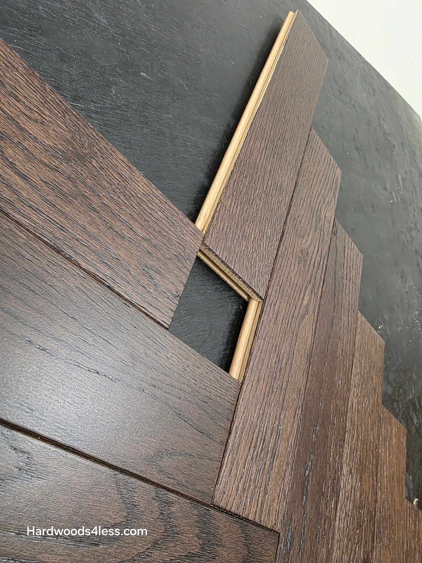3" x 15" x 3/4" Solid White Oak Salem Herringbone Hardwood Flooring. Shown on a black shooting table. Close up of the Tongue and Groove.