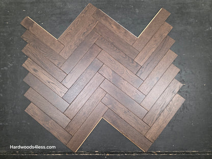 3" x 15" x 3/4" Solid White Oak Salem Herringbone Hardwood Flooring. Shown on a black shooting table. Close up.