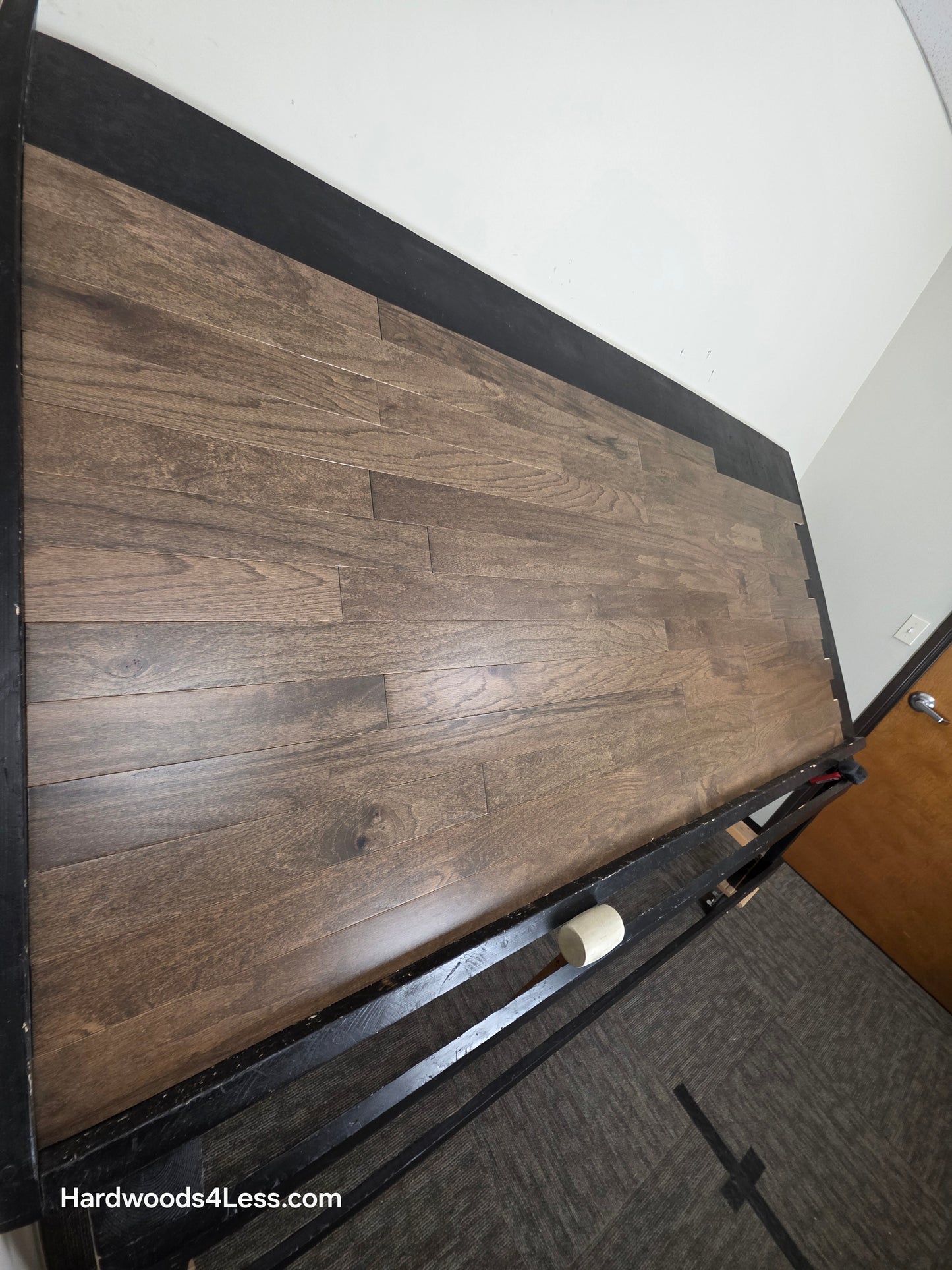 3" x 3/8" Engineered Red Oak Mace Hardwood Flooring. Shown on a black shooting table. Shot from steep left.