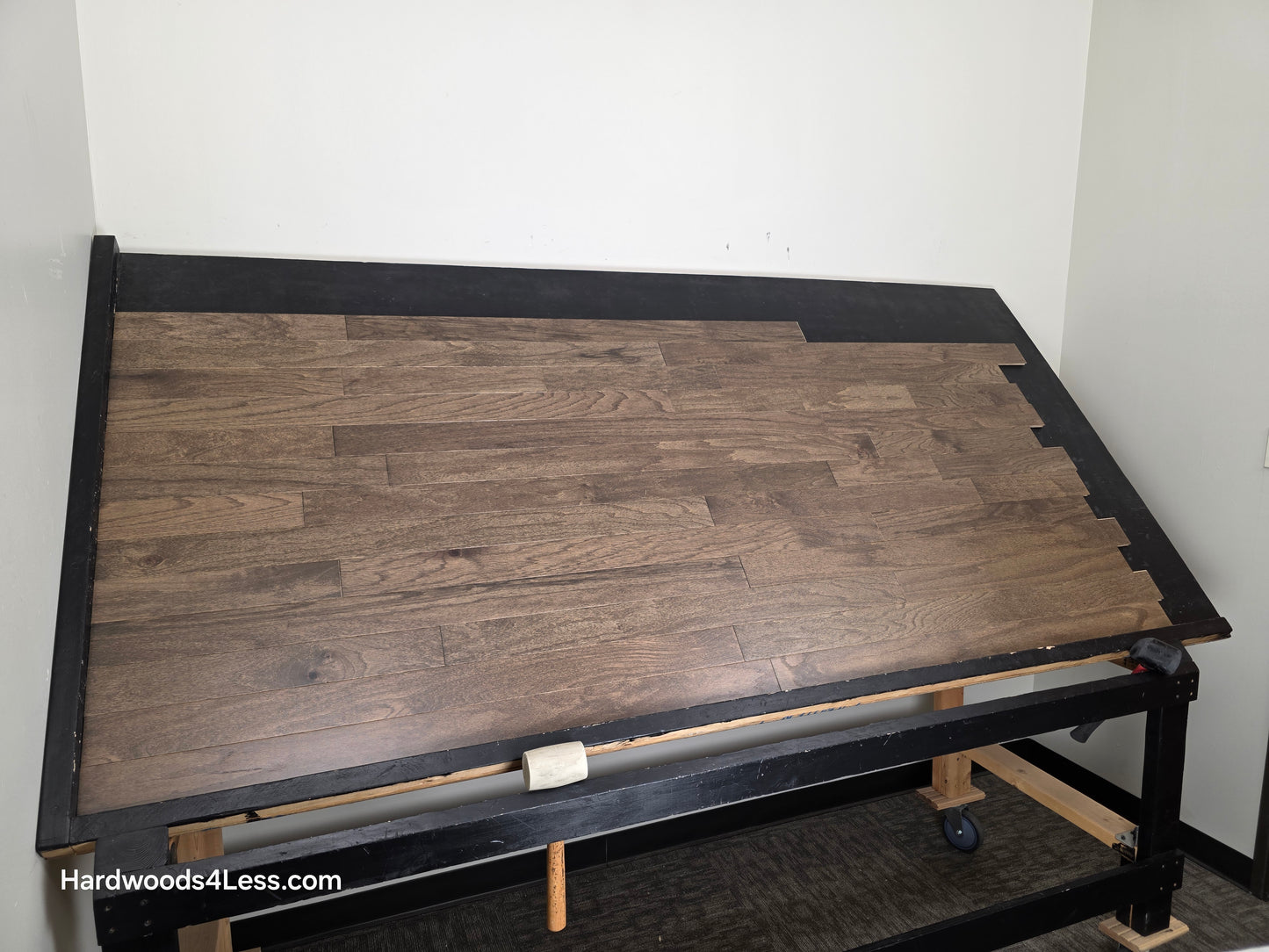 3" x 3/8" Engineered Red Oak Mace Hardwood Flooring. Shown on a black shooting table. Shot from wide left. 
