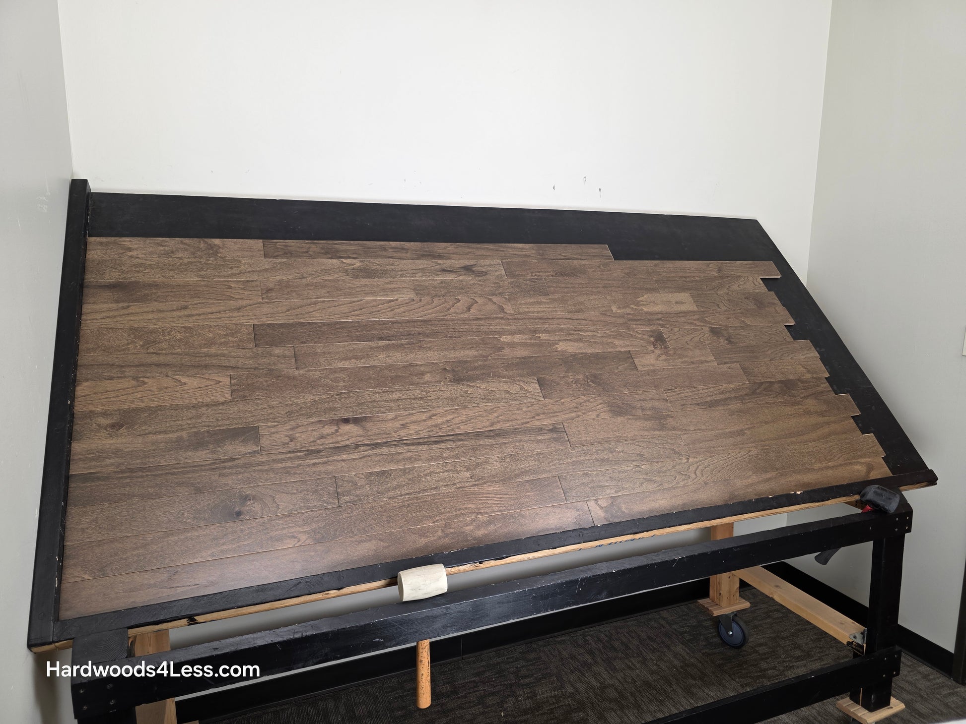 3" x 3/8" Engineered Red Oak Mace Hardwood Flooring. Shown on a black shooting table. Shot from wide left. 