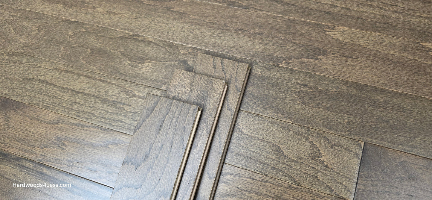 3" x 3/8" Engineered Red Oak Mace Hardwood Flooring. Shown with 3 flooring planks stacked on top of the red oak flooring. 
