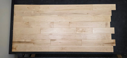 Maple HardWood flooring with a light brown color and visible grain pattern.