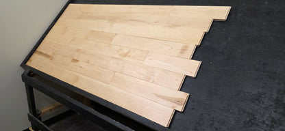 Maple HardWood flooring with a light brown color and visible grain pattern.