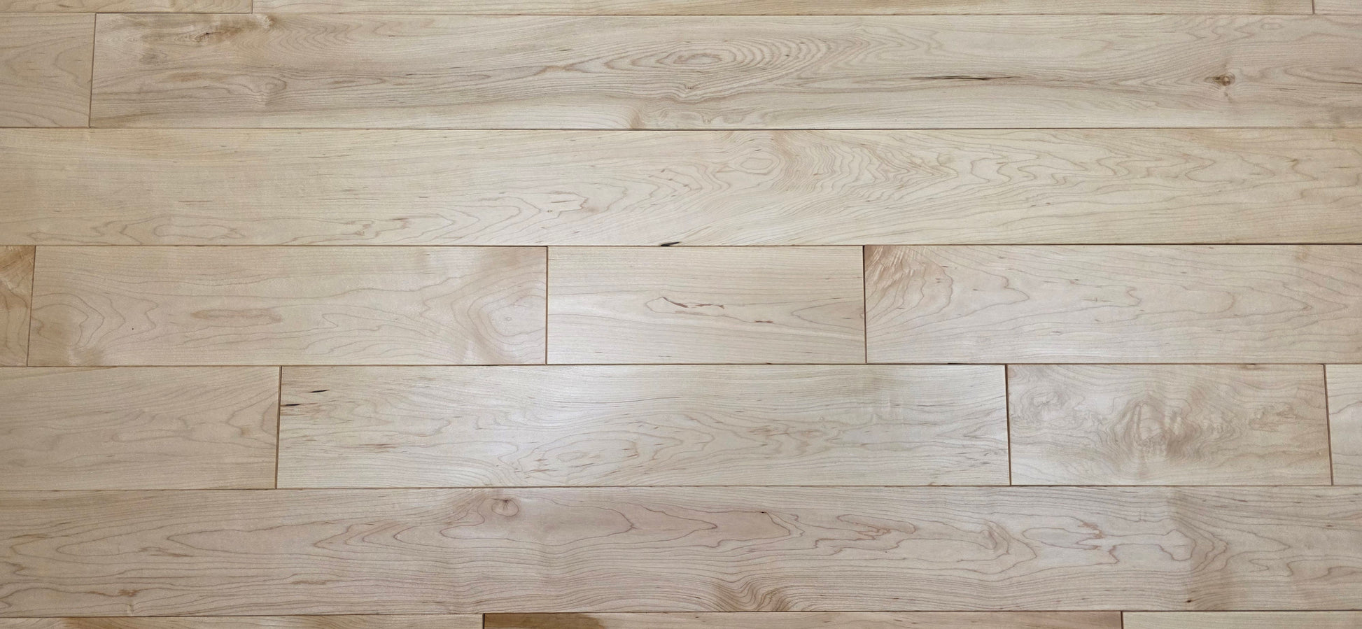 Maple HardWood flooring with a light brown color and visible grain pattern.