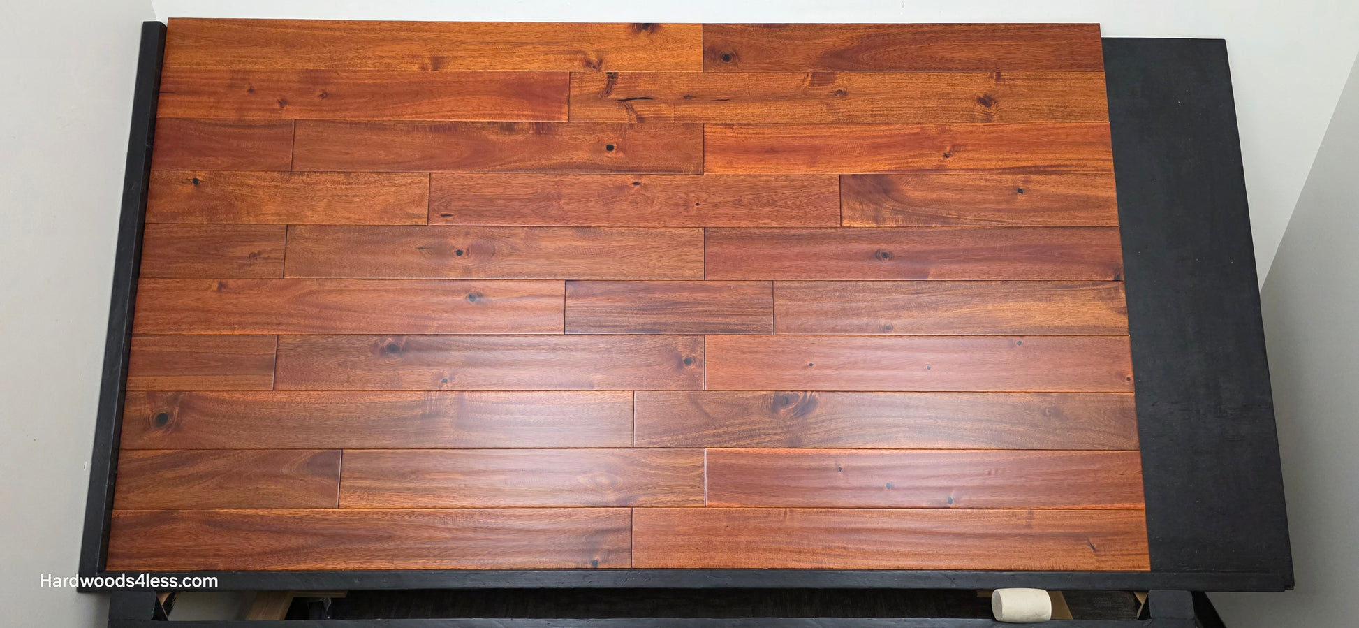 4 3/4" x 3/4" Solid Acacia Ancient Copper Hardwood Flooring. Shown on a black shooting table. Shot from Center.