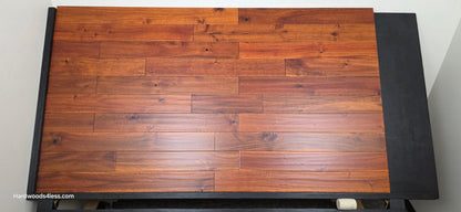 4 3/4" x 3/4" Solid Acacia Ancient Copper Hardwood Flooring. Shown on a black shooting table. Shot from Center.