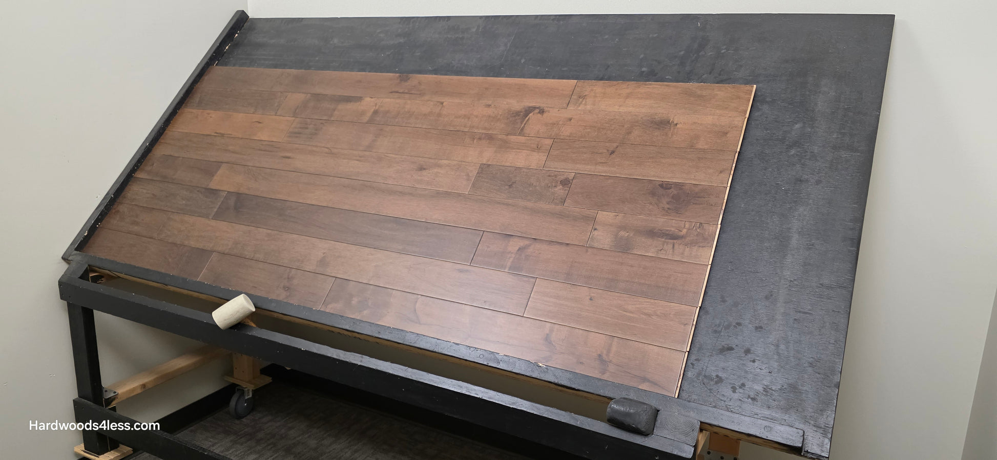 4 5/16" x 5/8" Engineered Maple Cabana Hardwood Flooring. Shown on a a black shooting table. Shot from wide right.