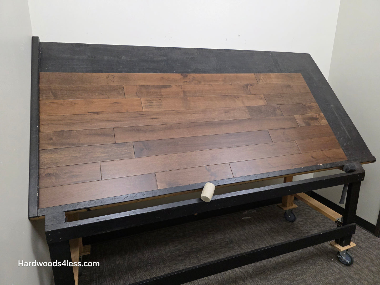 4 5/16" x 5/8" Engineered Maple Cabana Hardwood Flooring. Shown on a a black shooting table. Shot from wide left.