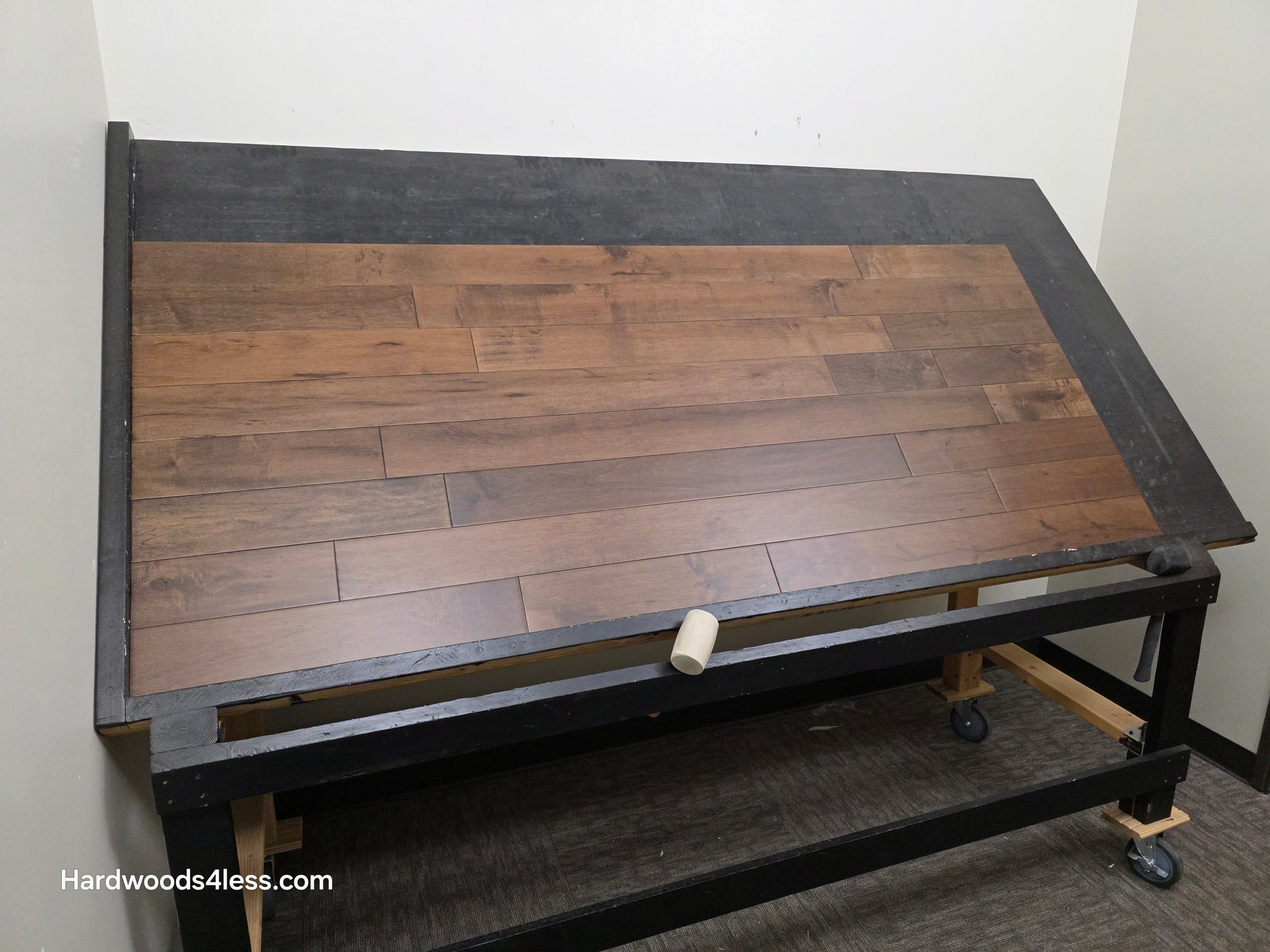 4 5/16" x 5/8" Engineered Maple Cabana Hardwood Flooring. Shown on a a black shooting table. Shot from wide left.