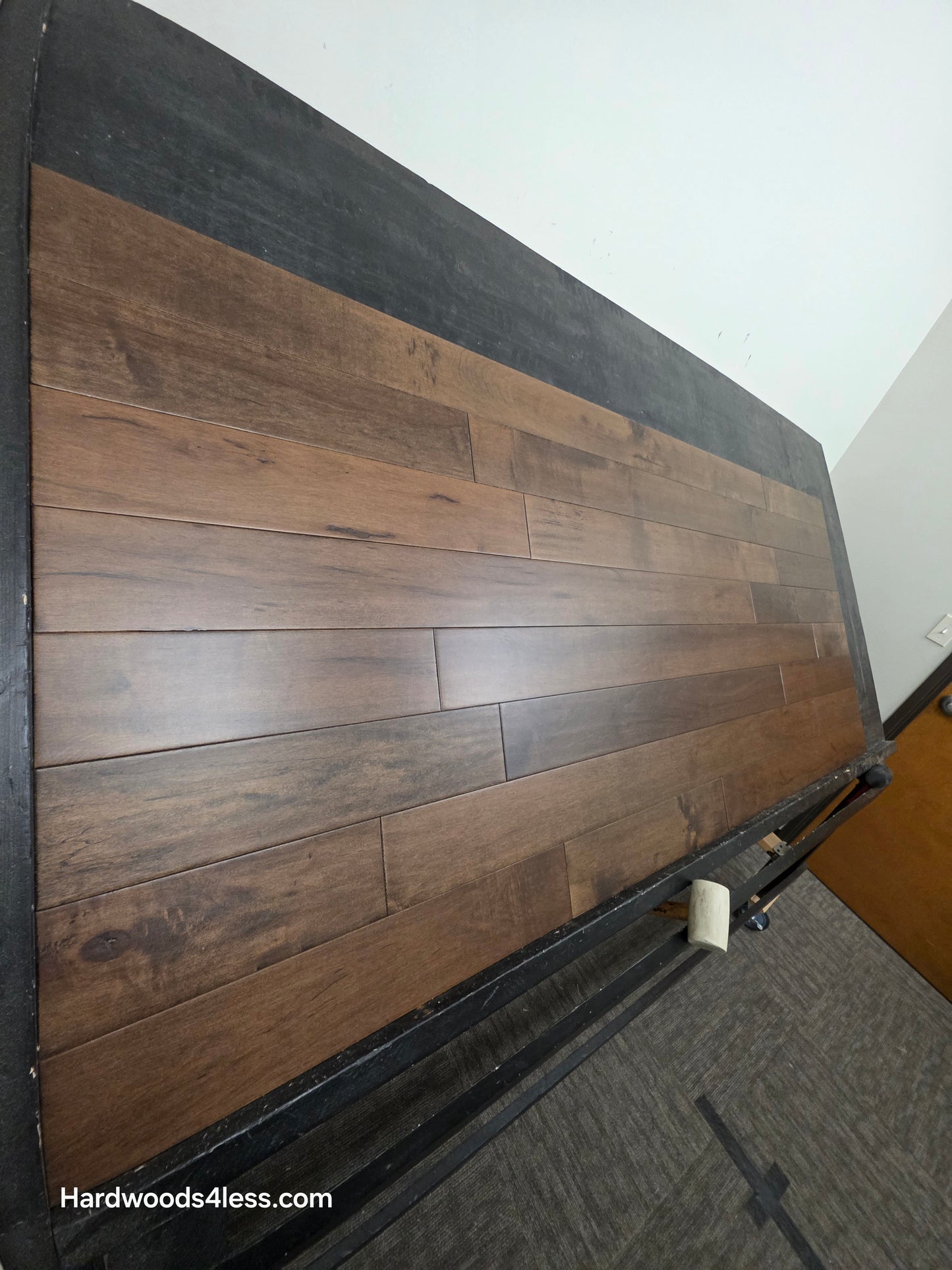 4 5/16" x 5/8" Engineered Maple Cabana Hardwood Flooring. Shown on a a black shooting table. Shot from steep left. 