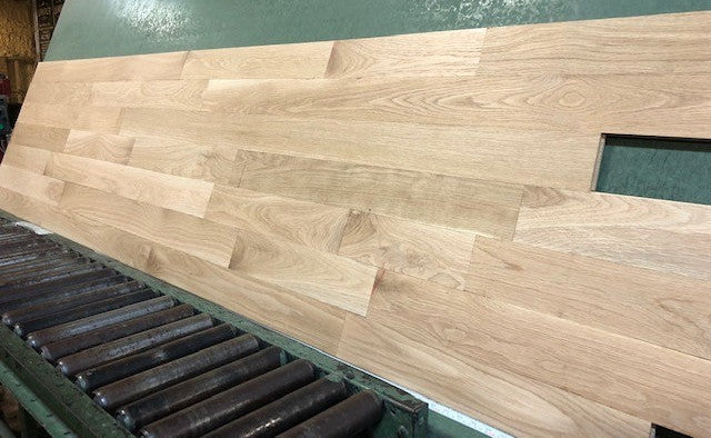 Unfinished White Oak Select & Better Solid Hardwood Flooring shown on a green rack left angle shot