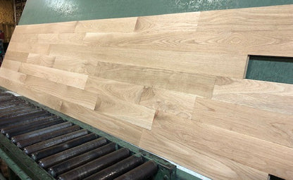 Unfinished White Oak Select & Better Solid Hardwood Flooring shown on a green rack left angle shot
