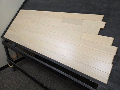 4" x 3/4" Solid Brazilian Oak Nevoa Hardwood Flooring shown on a black racking table from the right side