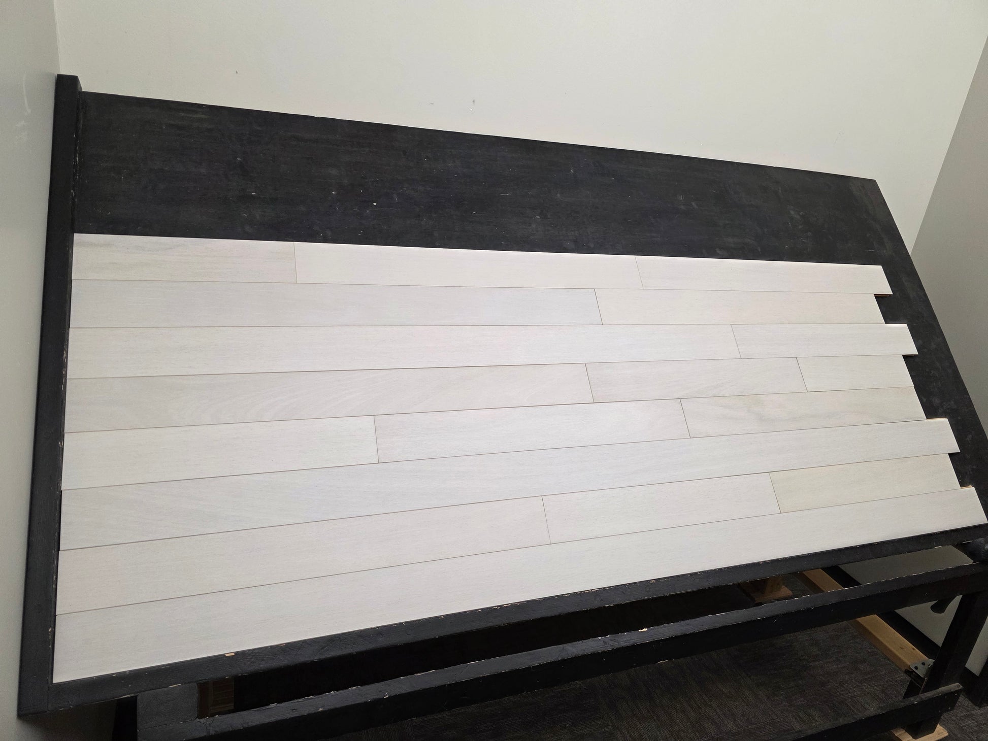 4" x 3/4" Solid Brazilian Oak Urso Hardwood Flooring on a black shooting table, wide left angle shot. 
