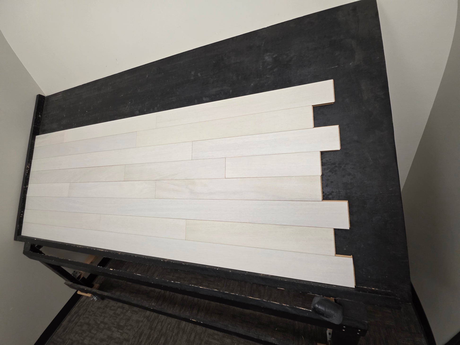 4" x 3/4" Solid Brazilian Oak Urso Hardwood Flooring on a black shooting table, right angle shot. 