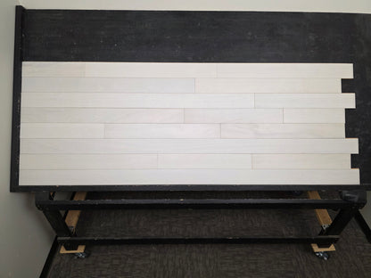 4" x 3/4" Solid Brazilian Oak Urso Hardwood Flooring on a black shooting table, head on shot. 