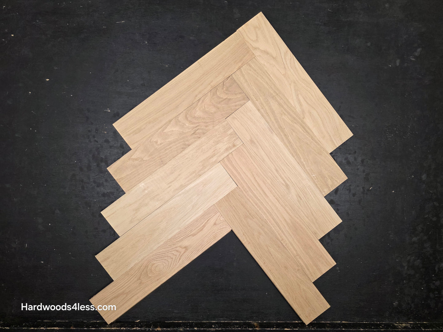 4" x 20" x 3/4" Solid Unfinished White Oak Herringbone Hardwood Flooring. Close up of a box. 